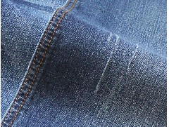 What is the purpose of mercerizing knitted denim?